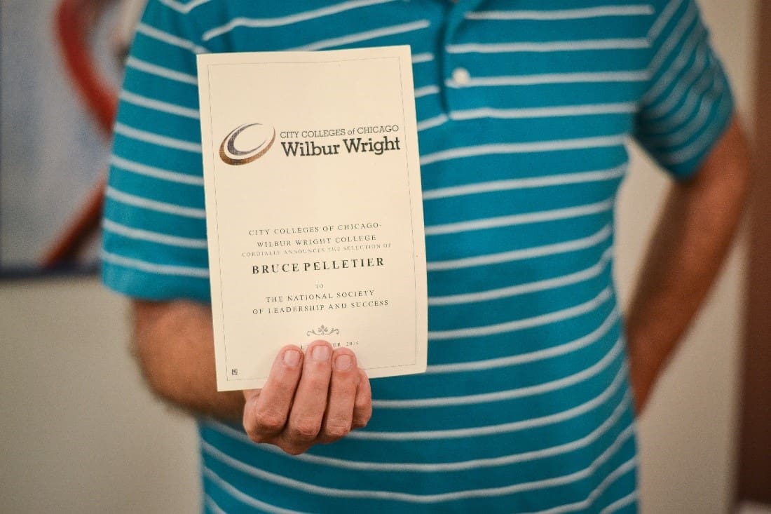 Bruce holding Wright College Invitation