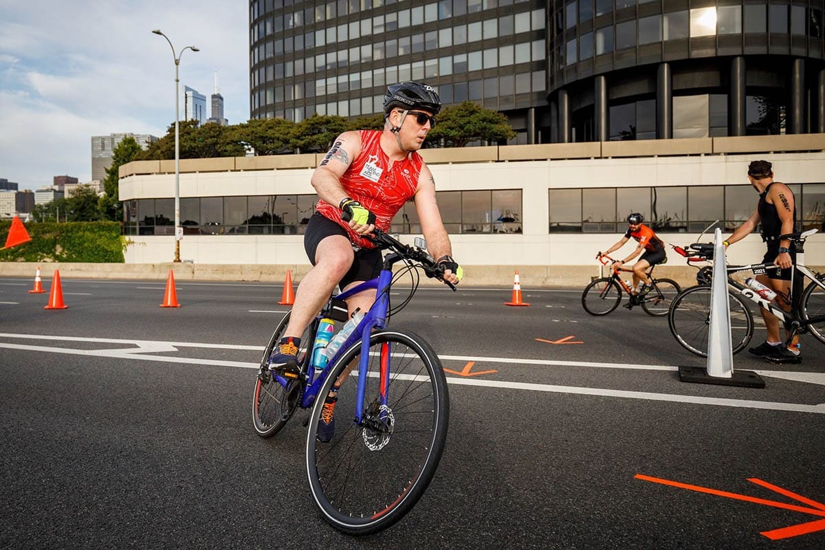 Zac riding a bike in the triathlon